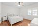 Comfortable bedroom features hardwood floors, white walls, and a white bed with side tables at 255 Fernbrook Dr, Mooresville, NC 28117