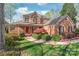 Charming two-story brick home with a red front door, manicured landscaping, and inviting curb appeal at 255 Fernbrook Dr, Mooresville, NC 28117