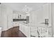 Modern kitchen with stainless steel appliances, granite countertops, and sleek white cabinetry at 255 Fernbrook Dr, Mooresville, NC 28117