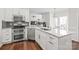 Bright kitchen features stainless steel appliances, double oven, gray backsplash, and granite countertops at 255 Fernbrook Dr, Mooresville, NC 28117