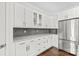 Modern kitchen boasts sleek white cabinets, stainless steel appliances, and granite countertops at 255 Fernbrook Dr, Mooresville, NC 28117