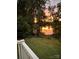 Picturesque lake view with vibrant sunset reflecting on the water, seen from a beautifully landscaped backyard at 255 Fernbrook Dr, Mooresville, NC 28117