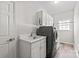 Functional laundry room with modern washer/dryer, sink, and ample storage space at 255 Fernbrook Dr, Mooresville, NC 28117