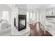Open concept living room with a fireplace, breakfast bar and view into the breakfast nook at 255 Fernbrook Dr, Mooresville, NC 28117