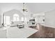Bright living room featuring a vaulted ceiling, a fireplace, and hardwood floors at 255 Fernbrook Dr, Mooresville, NC 28117