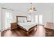 Spacious main bedroom with king bed, hardwood floors, ceiling fan, and French doors at 255 Fernbrook Dr, Mooresville, NC 28117
