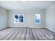 Bright bedroom with carpeted floors and two windows, allowing natural light to flood the space at 2579 Ruby Dixon Crossing Dr # 12, Gastonia, NC 28056