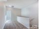 Upstairs hallway with carpet, staircase, and neutral color scheme at 2579 Ruby Dixon Crossing Dr # 12, Gastonia, NC 28056