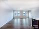 Open concept living room with hardwood floors and modern kitchen featuring a breakfast bar at 2579 Ruby Dixon Crossing Dr # 12, Gastonia, NC 28056
