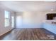 Open-concept living space features hardwood floors, a doorway, and a view of the modern kitchen at 2579 Ruby Dixon Crossing Dr # 12, Gastonia, NC 28056