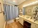 Well-lit bathroom featuring a vanity with sink, toilet, and a shower with blue curtain at 271 Ikerd Se Dr, Concord, NC 28025