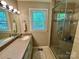 Bathroom with a glass enclosed shower and a granite countertop at 271 Ikerd Se Dr, Concord, NC 28025
