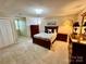 Bedroom with neutral carpeting, and wood furnishings at 271 Ikerd Se Dr, Concord, NC 28025