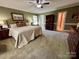 Cozy bedroom featuring carpet, neutral walls, ample natural light, and comfortable bed at 271 Ikerd Se Dr, Concord, NC 28025