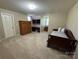 Bedroom with neutral carpeting, a twin bed, and built-in desk at 271 Ikerd Se Dr, Concord, NC 28025