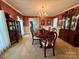 Elegant dining room featuring a chandelier, china cabinet, and classic dining set for formal entertaining at 271 Ikerd Se Dr, Concord, NC 28025