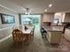 Dining room features large windows, access to the kitchen and wood furniture at 271 Ikerd Se Dr, Concord, NC 28025