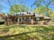 Charming brick home with dormer windows, black shutters, lush lawn, and mature trees offering curb appeal at 271 Ikerd Se Dr, Concord, NC 28025