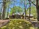 Brick home nestled among mature trees, providing privacy and a sense of tranquility at 271 Ikerd Se Dr, Concord, NC 28025