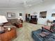 Carpeted living room features a brick wall, vaulted ceiling, ceiling fan, and access to the kitchen at 271 Ikerd Se Dr, Concord, NC 28025