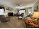 Carpeted living room featuring a brick fireplace, ceiling fan and lots of natural light at 271 Ikerd Se Dr, Concord, NC 28025