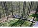 Backyard with walking trails and wooden outdoor patio in a wooded area at 2757 Trent Ne Dr, Conover, NC 28613