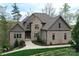 Charming brick home with manicured lawn, stone accents, and mature trees creates a welcoming curb appeal at 2757 Trent Ne Dr, Conover, NC 28613