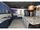 Well-lit kitchen showcasing granite countertops, custom blue cabinets, and a window seat at 2757 Trent Ne Dr, Conover, NC 28613