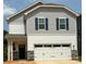 Charming two-story home featuring a white garage door and a stylish gray-and-white exterior at 277 Bezelle Ave, York, SC 29745