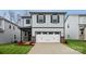 Charming two-story home with a two-car garage, blue shutters, and brick accents on the facade at 282 Bezelle Ave, York, SC 29745