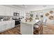 Bright kitchen features white cabinets, stainless steel appliances, an island with barstool seating, and hardwood floors at 282 Bezelle Ave, York, SC 29745