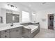 Bright bathroom featuring a soaking tub, double vanity with sinks, and a window bringing in natural light at 3081 Montreaux Valley Dr, Fort Mill, SC 29707