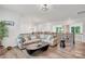 Open-concept living room with hardwood floors, comfortable seating, and plenty of natural light at 3081 Montreaux Valley Dr, Fort Mill, SC 29707