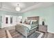 Spacious main bedroom featuring a large bed, wood floors, and ensuite bathroom with glass enclosed shower at 3081 Montreaux Valley Dr, Fort Mill, SC 29707