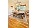 Dining room with modern light fixture, wood table, and a decorative rug on hardwood floors at 310 S Poston St, Shelby, NC 28150