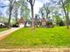 Charming brick home featuring a well-manicured front yard with mature trees and a single-car garage at 310 S Poston St, Shelby, NC 28150