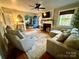 This cozy living room is complete with hardwood floors, plush seating, and a charming fireplace at 310 S Poston St, Shelby, NC 28150