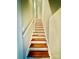 Stairway with painted risers, wooden treads, and white railing leading upstairs at 310 S Poston St, Shelby, NC 28150