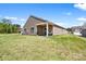 Spacious backyard with lush green grass and partial view of the covered patio, perfect for outdoor activities at 3664 Mercer St, Terrell, NC 28682