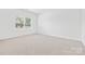 Neutral bedroom with carpet flooring and a large window offering great natural light at 3664 Mercer St, Terrell, NC 28682