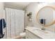 Clean bathroom with a shower and tub, a vanity with a round mirror, and a toilet at 3713 Capricorn Rd, Lancaster, SC 29720