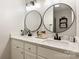 Updated bathroom featuring double sinks with modern black faucets and round mirrors at 3713 Capricorn Rd, Lancaster, SC 29720