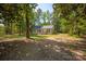 Exterior view of home surrounded by lots of trees and a green lawn at 3713 Capricorn Rd, Lancaster, SC 29720