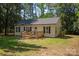 A cozy single-story home featuring a wooden porch and surrounded by lush greenery at 3713 Capricorn Rd, Lancaster, SC 29720