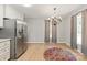 An open-concept kitchen with stainless steel appliances, pendant lighting, and hardwood floors at 3713 Capricorn Rd, Lancaster, SC 29720