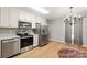 The kitchen has stainless steel appliances, white cabinetry, and a view of the backyard from the window at 3713 Capricorn Rd, Lancaster, SC 29720