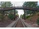 Scenic view of railroad tracks with an overhead bridge adorned with American flags at 3713 Capricorn Rd, Lancaster, SC 29720