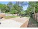 Lush backyard with a brick patio, a fire pit, and privacy fencing at 415 French St, Charlotte, NC 28216