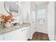 Stylish bathroom featuring granite countertop, modern fixtures, and a decorative round mirror at 415 French St, Charlotte, NC 28216
