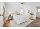 Serene bedroom with a plush bed, neutral decor, hardwood floors, and natural light at 415 French St, Charlotte, NC 28216